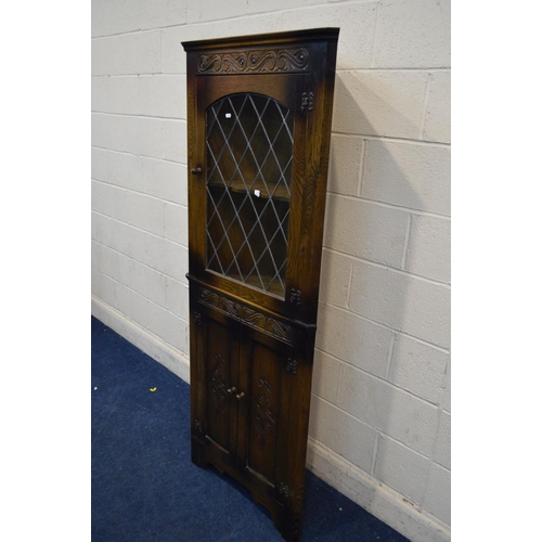 1237 - A REPRODUCTION OAK LEAD GLAZED SINGLE DOOR CORNER CUPBOARD, above double cupboard doors, approximate... 