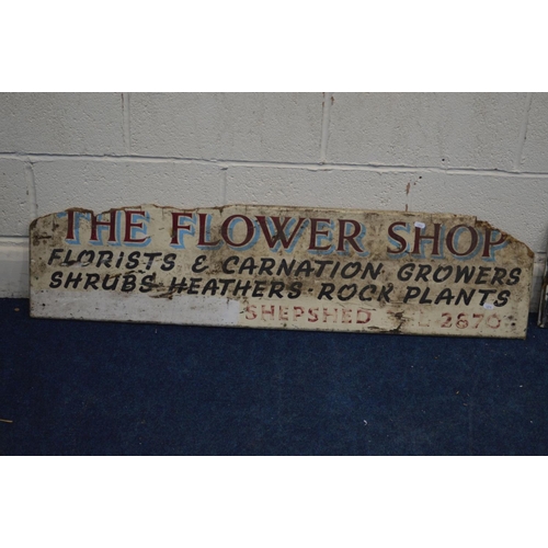 1241 - A WHITE PAINTED WOODEN ADVERTISING SIGN, reading 'The Flower Shop', width 122cm, together with two o... 