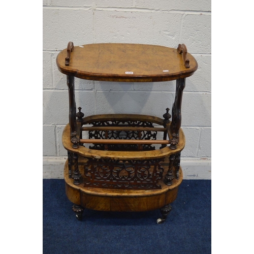 1248 - A LATE VICTORIAN BURR WALNUT CANTERBURY, shaped oval top with handles, on foliate scrolling end supp... 