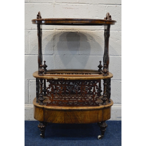 1248 - A LATE VICTORIAN BURR WALNUT CANTERBURY, shaped oval top with handles, on foliate scrolling end supp... 