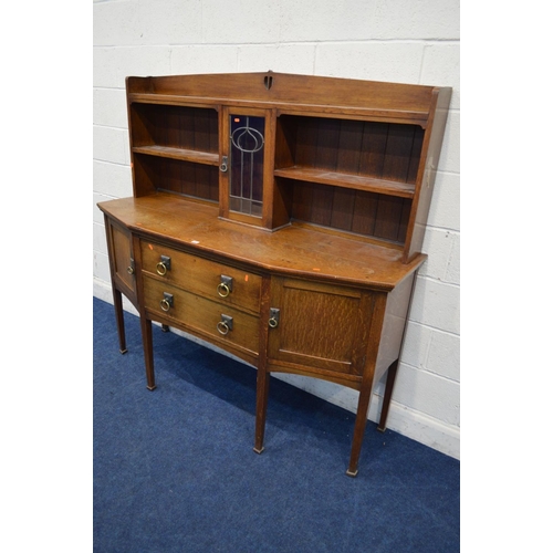 1251 - AN EARLY 20TH CENTURY OAK ARTS & CRAFTS SIDEBOARD, the top with shelves flanking a single lead glaze... 