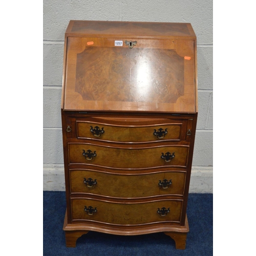 1257 - A SLIM REPRODUCTION YEW WOOD SERPENTINE FALL FRONT BUREAU, four drawers on bracket feet, width 53cm ... 