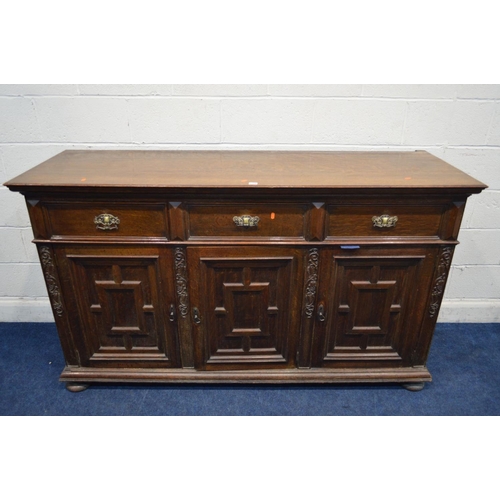 1259 - AN EARLY 20TH CENTURY OAK SIDEBOARD, with three drawers, above three geometric panelled doors, width... 