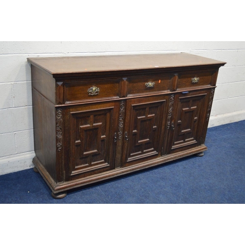 1259 - AN EARLY 20TH CENTURY OAK SIDEBOARD, with three drawers, above three geometric panelled doors, width... 