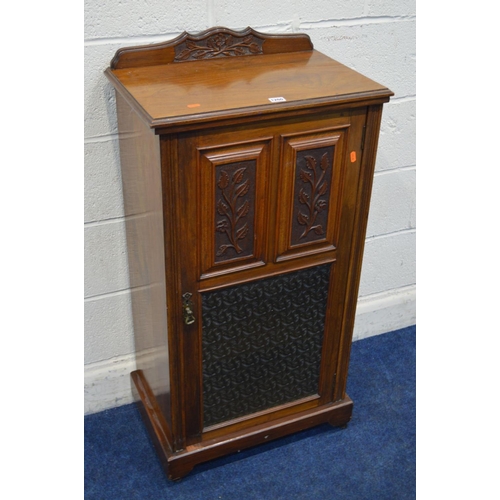 1260 - AN EDWARDIAN WALNUT SINGLE DOOR CABINET, with foliate panelled doors above a glass panel, width 54cm... 