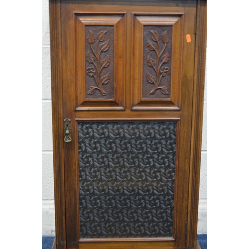 1260 - AN EDWARDIAN WALNUT SINGLE DOOR CABINET, with foliate panelled doors above a glass panel, width 54cm... 