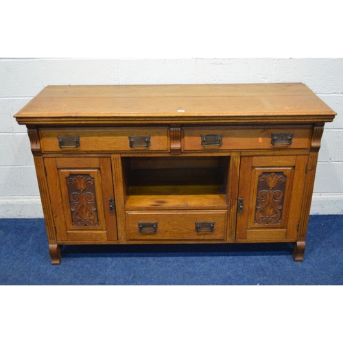 1261 - AN EARLY 20TH CENTURY GOLDEN OAK SIDEBOARD, with two long drawers above two foliate panelled doors, ... 