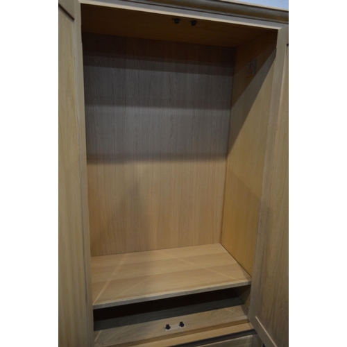 1262 - A MODERN OAK THREE PIECE BEDROOM SUITE, comprising a double door wardrobe above a single drawer, wid... 