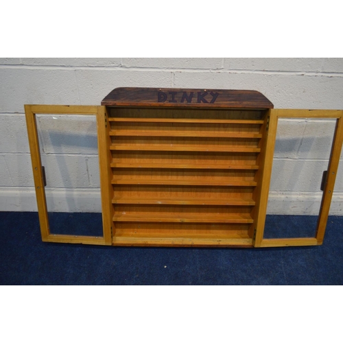 1266 - A TEAK GLAZED DOUBLE DOOR WALL HANGING DISPLAY CABINET, with later written Dinky, width 77cm x depth... 