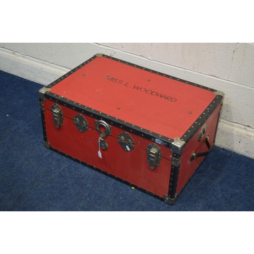 1268 - A VINTAGE RED GROUND TRAVELLING TRUNK, and a circular tin (2)