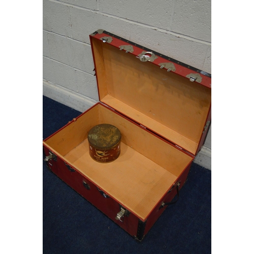 1268 - A VINTAGE RED GROUND TRAVELLING TRUNK, and a circular tin (2)