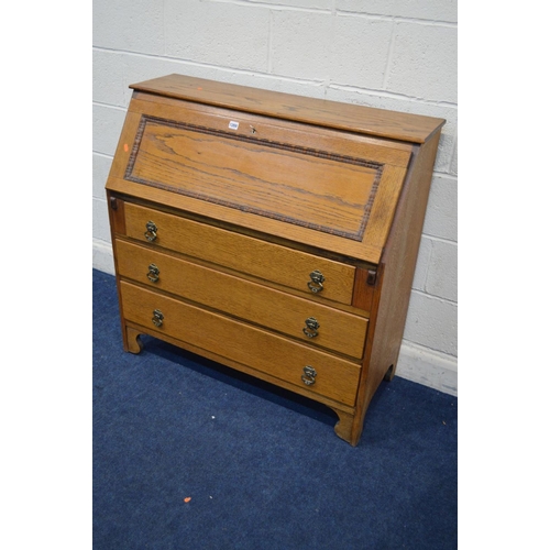 1269 - A MID 20TH CENTURY GOLDEN OAK FALL FRONT BUREAU, with a fitted interior above three drawers, width 1... 