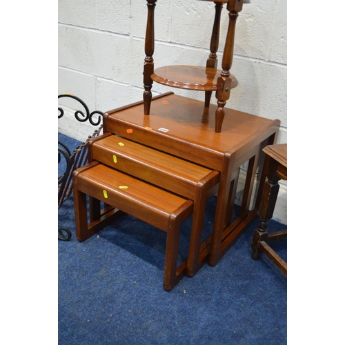 1290 - A 1970'S TEAK NEST OF THREE TABLES, together with a wrought iron magazine rack and two occasional ta... 