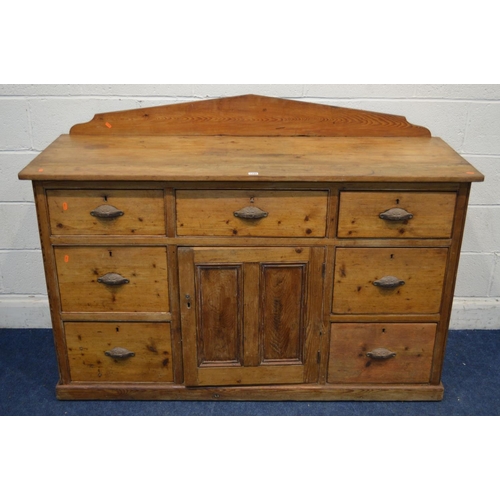 1299 - A VICTORIAN PITCH PINE SIDEBOARD, with a shaped back, seven assorted drawers with cupped handles fla... 