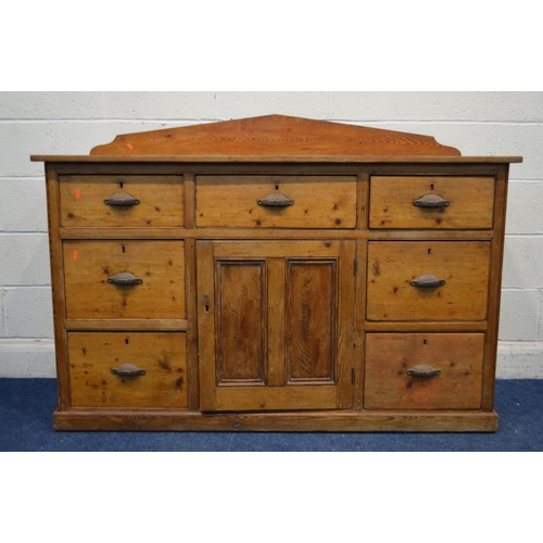 1299 - A VICTORIAN PITCH PINE SIDEBOARD, with a shaped back, seven assorted drawers with cupped handles fla... 