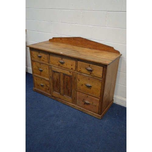 1299 - A VICTORIAN PITCH PINE SIDEBOARD, with a shaped back, seven assorted drawers with cupped handles fla... 