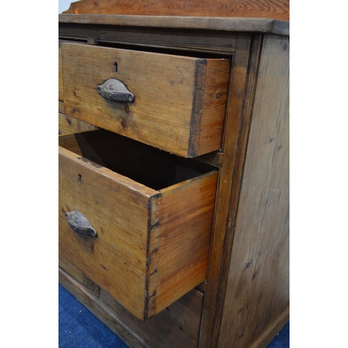 1299 - A VICTORIAN PITCH PINE SIDEBOARD, with a shaped back, seven assorted drawers with cupped handles fla... 