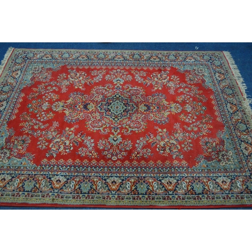 1300 - A MODERN RED GROUND RUG, 242cm x 171cm