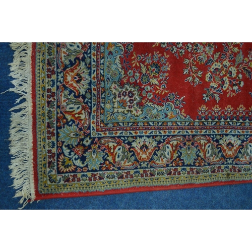 1300 - A MODERN RED GROUND RUG, 242cm x 171cm