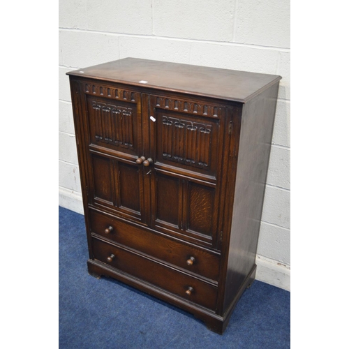 1309 - A REPRODUCTION OAK LINENFOLD TWO DOOR CABINET, with two drawers, width 86cm x depth 47cm x height 11... 