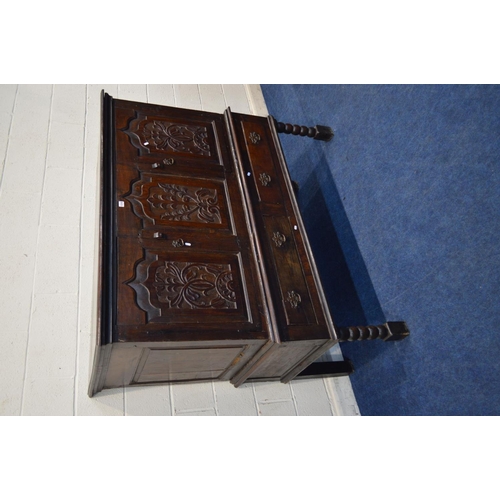 1310 - AN 18TH CENTURY AND LATER CARVED OAK TWO DOOR DEUDDARN, carved triple panel front, above two drawers... 