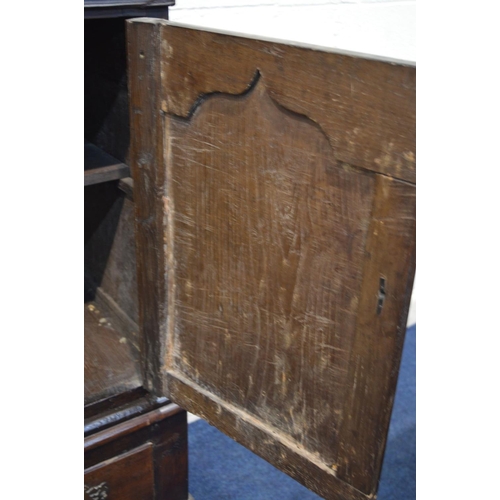 1310 - AN 18TH CENTURY AND LATER CARVED OAK TWO DOOR DEUDDARN, carved triple panel front, above two drawers... 