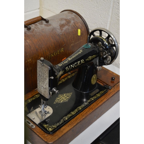 1343 - TWO VINTAGE OAK CASED SINGER SEWING MACHINES, together with a cased Merritt sewing machine and a bra... 