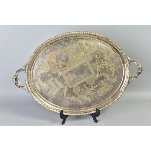 138 - A LATE VICTORIAN SILVER PLATE TWIN HANDLED TRAY OF OVAL FORM, engraved with birds and flowers, overa... 