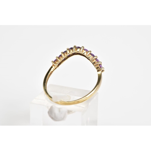 22 - A 9CT GOLD AMETHYST SET RING, of V shape design set with nine circular cut amethyst, to the plain ba... 