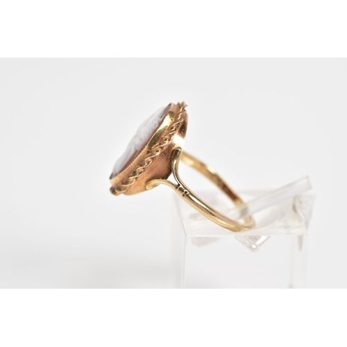 25 - A 9CT GOLD CAMEO RING, of oval design depicting a lady in profile with a rope twist surround, to the... 