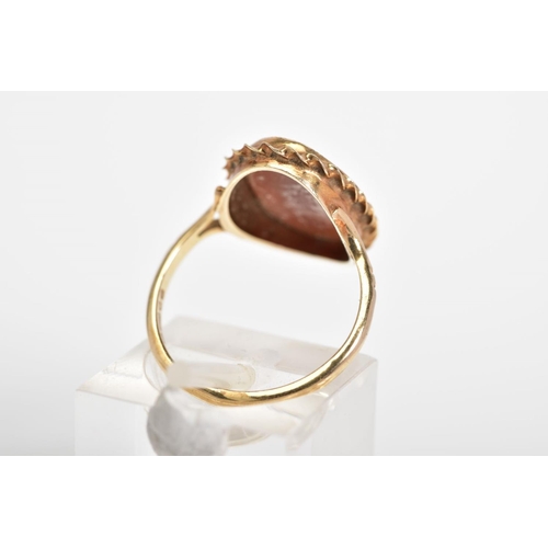 25 - A 9CT GOLD CAMEO RING, of oval design depicting a lady in profile with a rope twist surround, to the... 