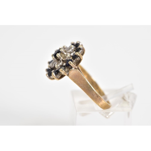 27 - A 9CT GOLD CLUSTER RING, a three tiered cluster design set with a central circular cut sapphire, sin... 