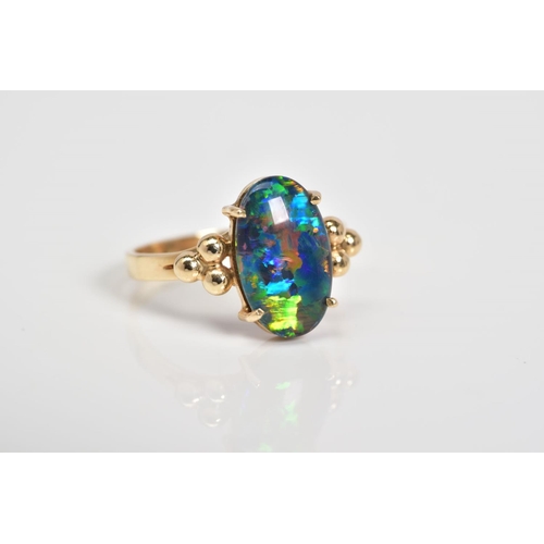 3 - AN OPAL TRIPLET RING, the oval opal triplet set within a four claw setting, to the bead detail shoul... 