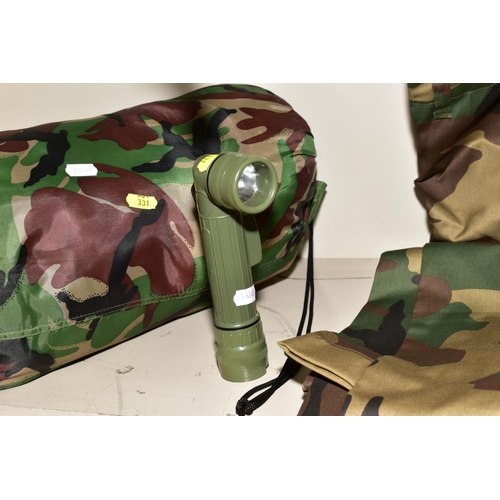 331 - A GROUP OF MILITARY/CAMOFLAGE CLOTHING AND ACCESSORIES, to include ruck sack, sleeping bag, torch, t... 