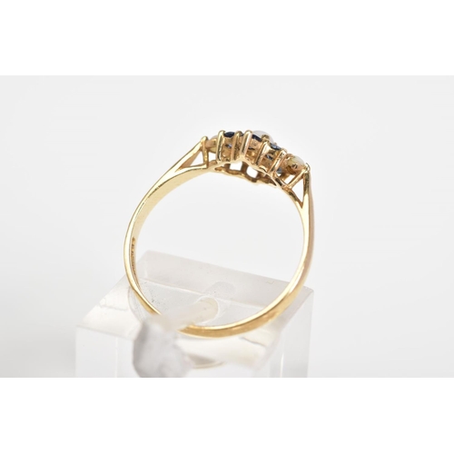 34 - A 9CT GOLD CLUSTER RING, set with a central cultured seed pearl, with a circular cut sapphire surrou... 