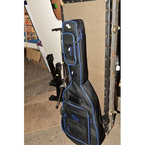 341 - A RECTANGULAR HARD CASE FOR AN ELECTRIC GUITAR, a soft guitar case, four guitar stands and a folding... 