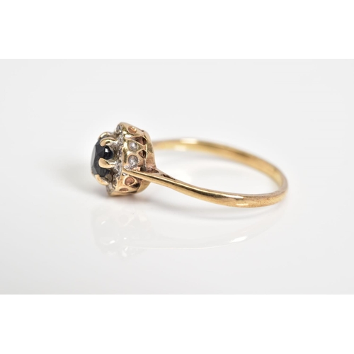 37 - A 9CT GOLD CLUSTER RING, set with a central oval cut sapphire and single cut diamond surround, to th... 