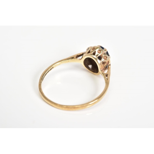 37 - A 9CT GOLD CLUSTER RING, set with a central oval cut sapphire and single cut diamond surround, to th... 