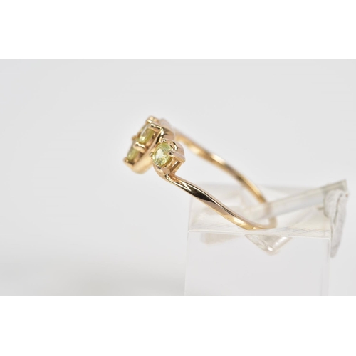 38 - A 9CT GOLD RING, designed with a central heart panel set with three circular cut stones assessed as ... 