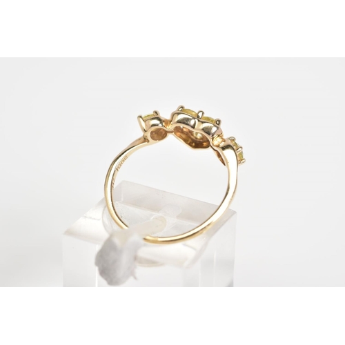 38 - A 9CT GOLD RING, designed with a central heart panel set with three circular cut stones assessed as ... 