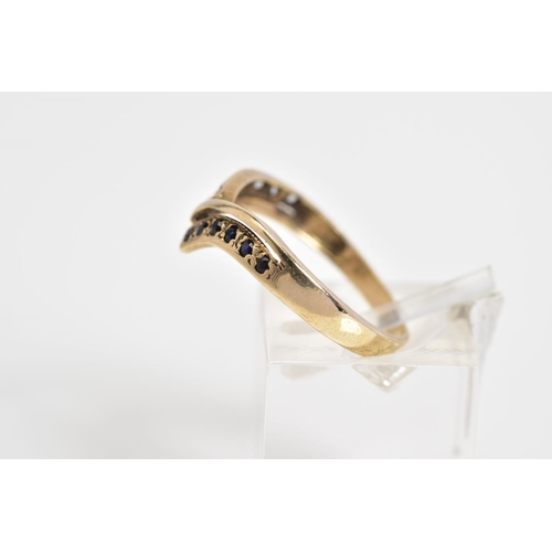 41 - A 9CT GOLD V SHAPE RING, the V shape design set with a row of circular cut sapphires and a row of ci... 