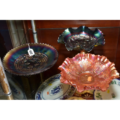 422 - TWO PURPLE CARNIVAL GLASS FOOTED DISHES, one with grape decoration, approximate diameter 23cm and th... 