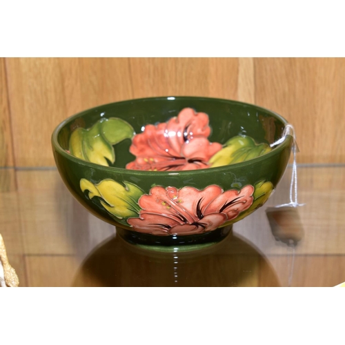 437 - A MOORCROFT POTTERY FOOTED BOWL, 'Hibiscus' pattern on green ground, impressed backstamp and painted... 