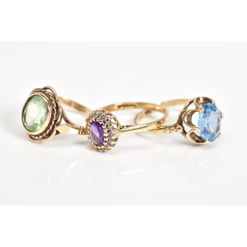 53 - THREE 9CT GOLD GEM SET RINGS, to include an oval cut topaz within a scallop surround, with a 9ct hal... 