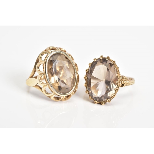 54 - TWO 9CT GOLD SMOKEY QUARTZ RINGS, the first designed with a large oval cut smokey quartz, within a s... 