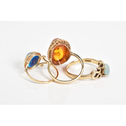 55 - THREE 9CT GOLD GEM SET RINGS, to include an oval cut amber cabochon within a rope twist surround, wi... 