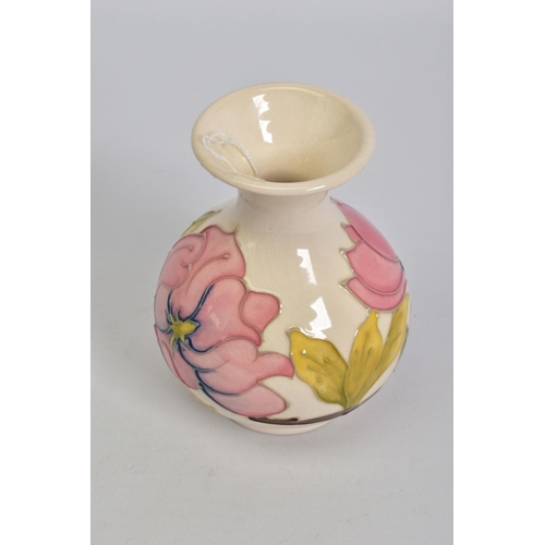 555 - A MOORCROFT POTTERY SQUAT BALUSTER VASE, cream ground with pink magnolia, crazed, impressed and pain... 