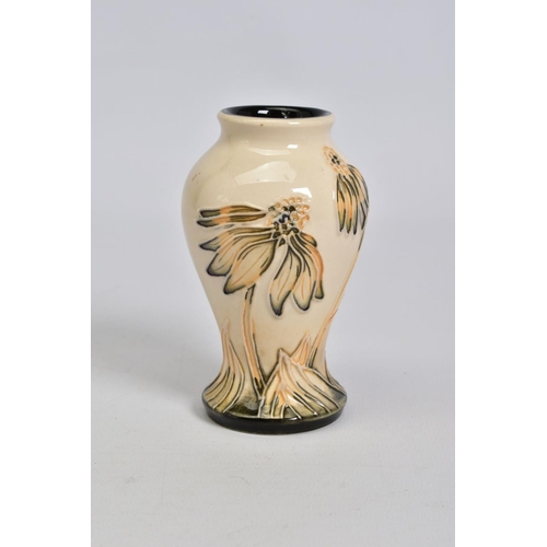 559 - A MODERN MOORCROFT POTTERY SMALL BALUSTER VASE, decorated in a cornflower pattern, impressed, painte... 