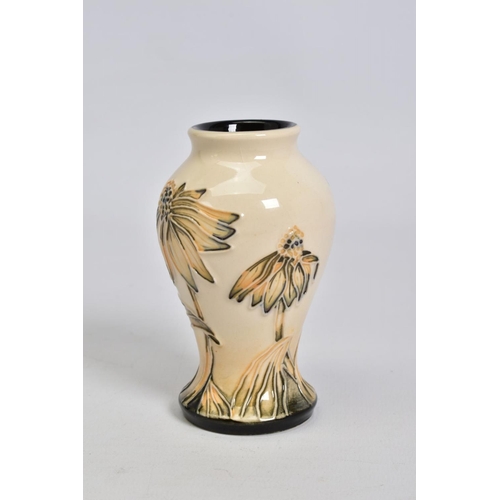 559 - A MODERN MOORCROFT POTTERY SMALL BALUSTER VASE, decorated in a cornflower pattern, impressed, painte... 