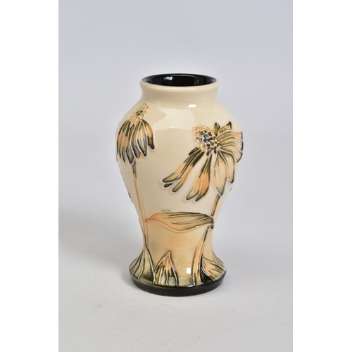 559 - A MODERN MOORCROFT POTTERY SMALL BALUSTER VASE, decorated in a cornflower pattern, impressed, painte... 